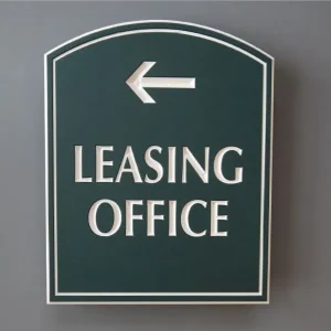 Office direction sign that says leasing office with an arrowing pointing to the left