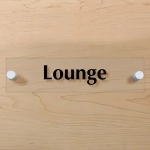 Room sign that says lounge on a wall with white stand offs