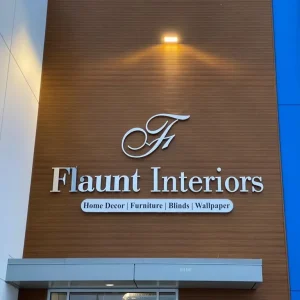 Silver cut 3D letter sign installed on the exterior of building.