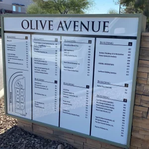 A directory monument sign installed outside of a business complex showing names and unit numbers.